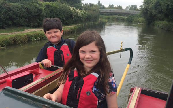 Children steering the canal boat